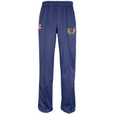 The Gray Nicolls Monmouth CC Matrix V2 T20 Trouser is a navy blue athletic cricket pant with an elastic waistband, loose straight-leg fit, and two embroidered crests on the front thighs—one red and white, one multicolored.