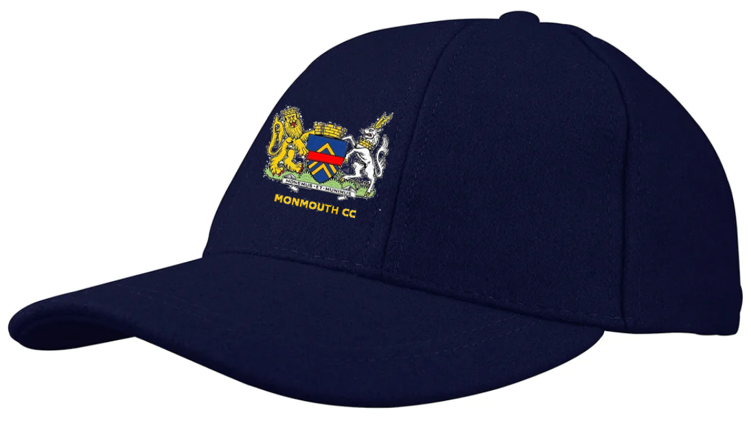 The Gray Nicolls Monmouth CC Melton County Cap is a unisex navy cap with a colorful crest—lion, shield, and unicorn—above embroidered "MONMOUTH CC" and the club’s classic navy logo on the front.