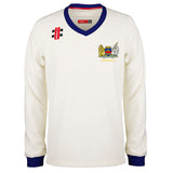 The Gray Nicolls Monmouth CC Larger Sizes Junior Pro Performance Sweater features long sleeves, blue cuffs and collar, the club crest on the chest, plus logo details—perfect for junior players seeking a pro look.