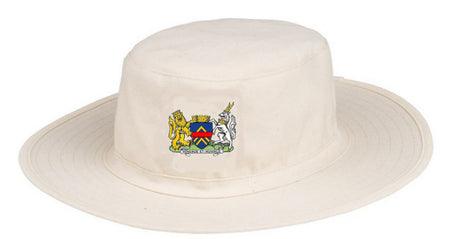 The Monmouth CC Junior Fielders Sun Hat by Martin Berrill Sports is an off-white, wide-brimmed hat featuring a colorful coat of arms with a lion and unicorn flanking a shield on the front.