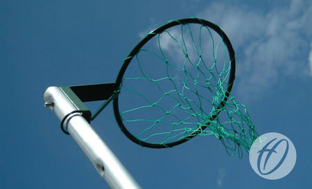 A close-up of a Harrod Sport Practice Netball Net and hoop, photographed from below against a clear blue sky with clouds—ideal for refining your shots on training nets.