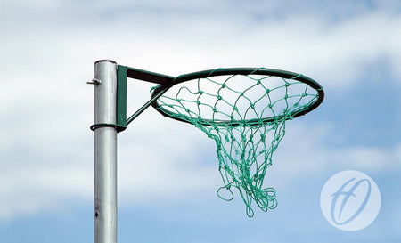 A close-up of Harrod Sport Regulation Netball Rings - 16mm (Pair), featuring a green net and durable tubular steel, set outdoors against a blue sky with light clouds.