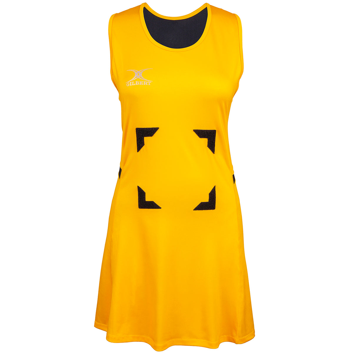The Gilbert Synergie Netball Dress is sleeveless and yellow, featuring black neck trim, black velcro patches on the front, and a small white Gilbert logo on the left chest.