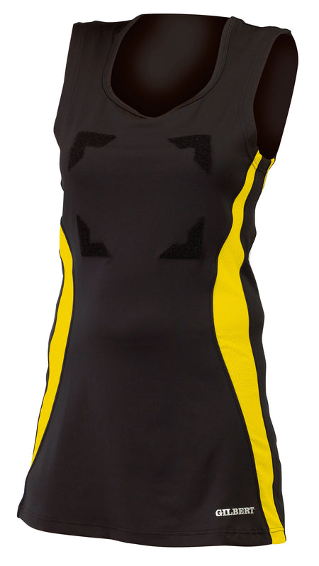 The Gilbert Eclipse Netball Dress by Gilbert in Black/Gold features yellow side panels, front angular black markings, a V-neck, and “GILBERT” printed near the hem—ideal as a fitted women’s netball uniform.
