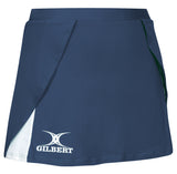 The Gilbert Helix II Netball Skort by Gilbert is navy with an overlapping front, white Gilbert logo and emblem on the lower left, white inner hem accent, and an elasticated waistband for a secure fit.