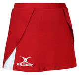 The Gilbert Helix II Netball Skort in red features a wrap-style front, white inner lining, built-in shorts for comfort, and the Gilbert logo in white near the bottom hem.