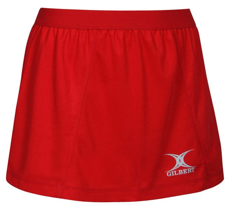 The Gilbert Blaze Netball Skirt is a plain red sports skirt with an elastic waistband and a white Gilbert logo near the hem, combining comfort and style for active days.