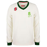 The Martin Berrill Sports National Star College CC Pro Performance Sweater is long-sleeve, white, with a dark green collar and cuffs, Club Logo and National Star College emblem in green on the left chest, plus small shoulder logos.