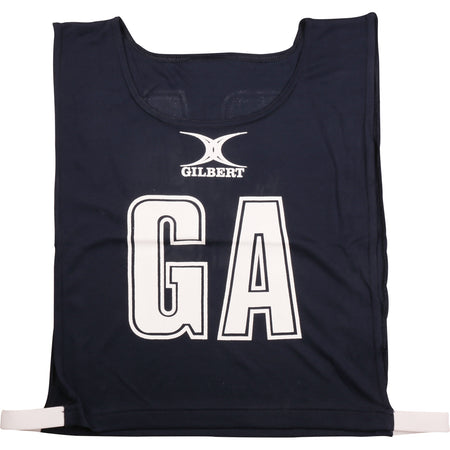 The Gilbert Netball Bibs in navy feature large white GA letters on the front, the Gilbert logo above, and white side straps. Made from breathable polyester for comfort during play.
