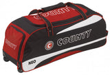 The Hunts County Neo Wheelie Cricket Bag is a red and black holdall with COUNTY on the side, wheels at one end, a top handle, and NEO printed near the bottom—ideal for carrying your cricket gear.