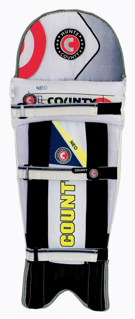 The Hunts County Neo Junior Batting Pads feature padded, ambidextrous protection with black, white, yellow, and red accents, multiple securing straps, and COUNTY & HUNTS COUNTY logos—ideal for junior cricketers.