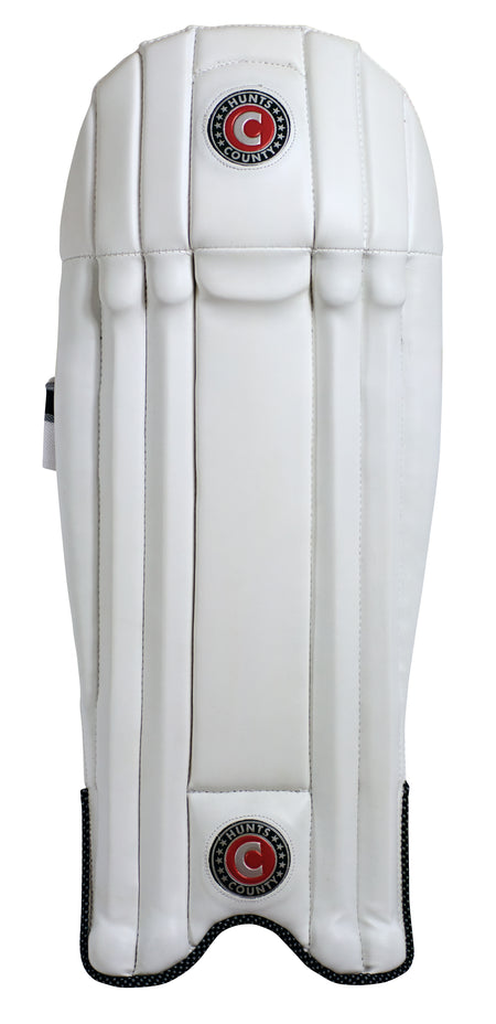 The Hunts County Neo Wicket Keeping Pad by Hunts County features vertical padding stripes and circular logos near the top and bottom, offering superior cane protection, displayed on a plain white background.