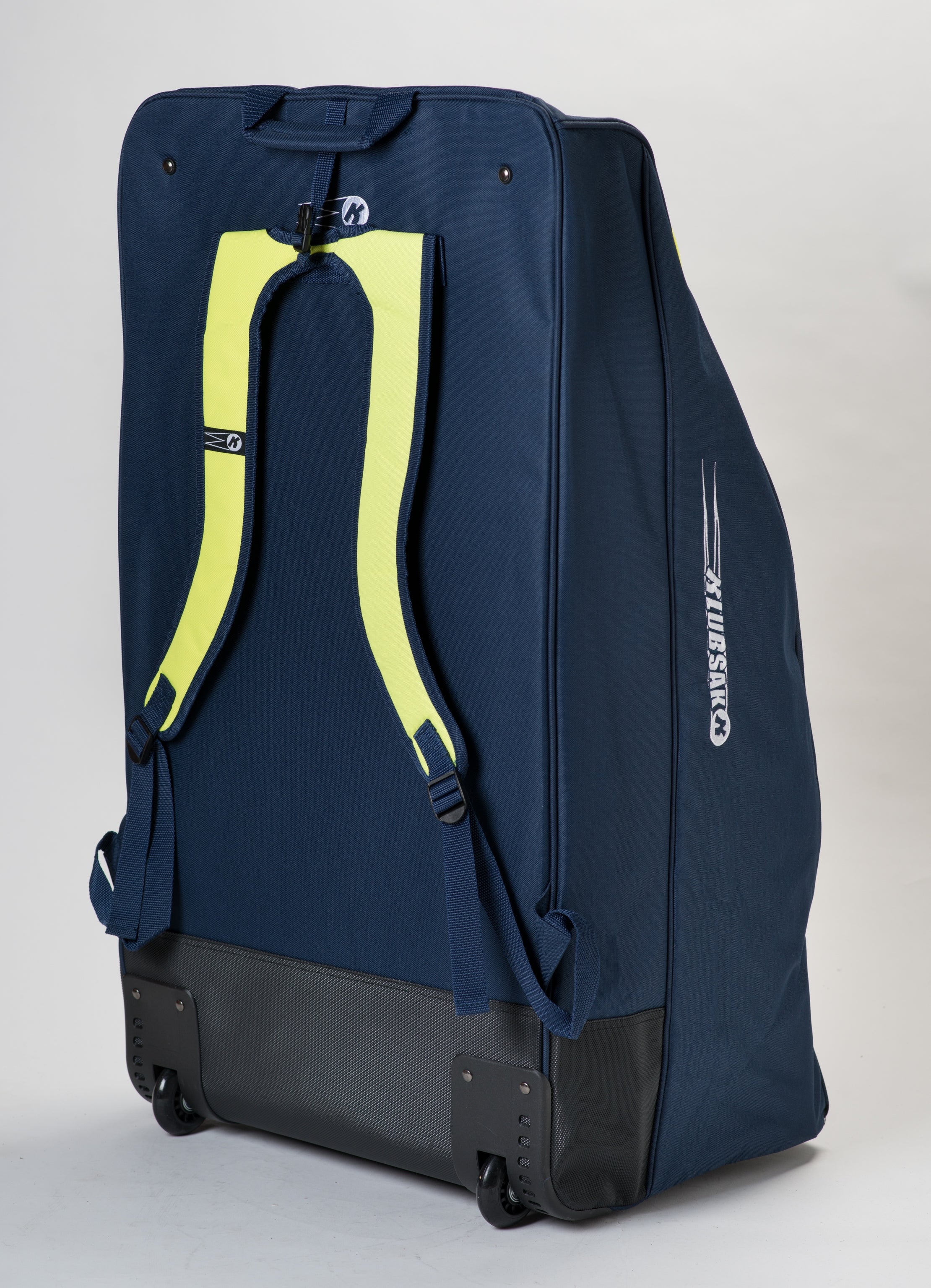 A large navy blue Katchet KoachSak Pro sports bag with black wheels stands upright on a plain background, featuring yellow backpack-style straps and a side logo.