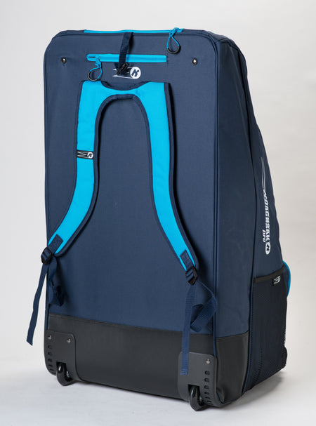 The Katchet KoachSak Pro, a large navy sports bag with bright blue backpack straps, black wheels, and a handle, stands upright against a white background.