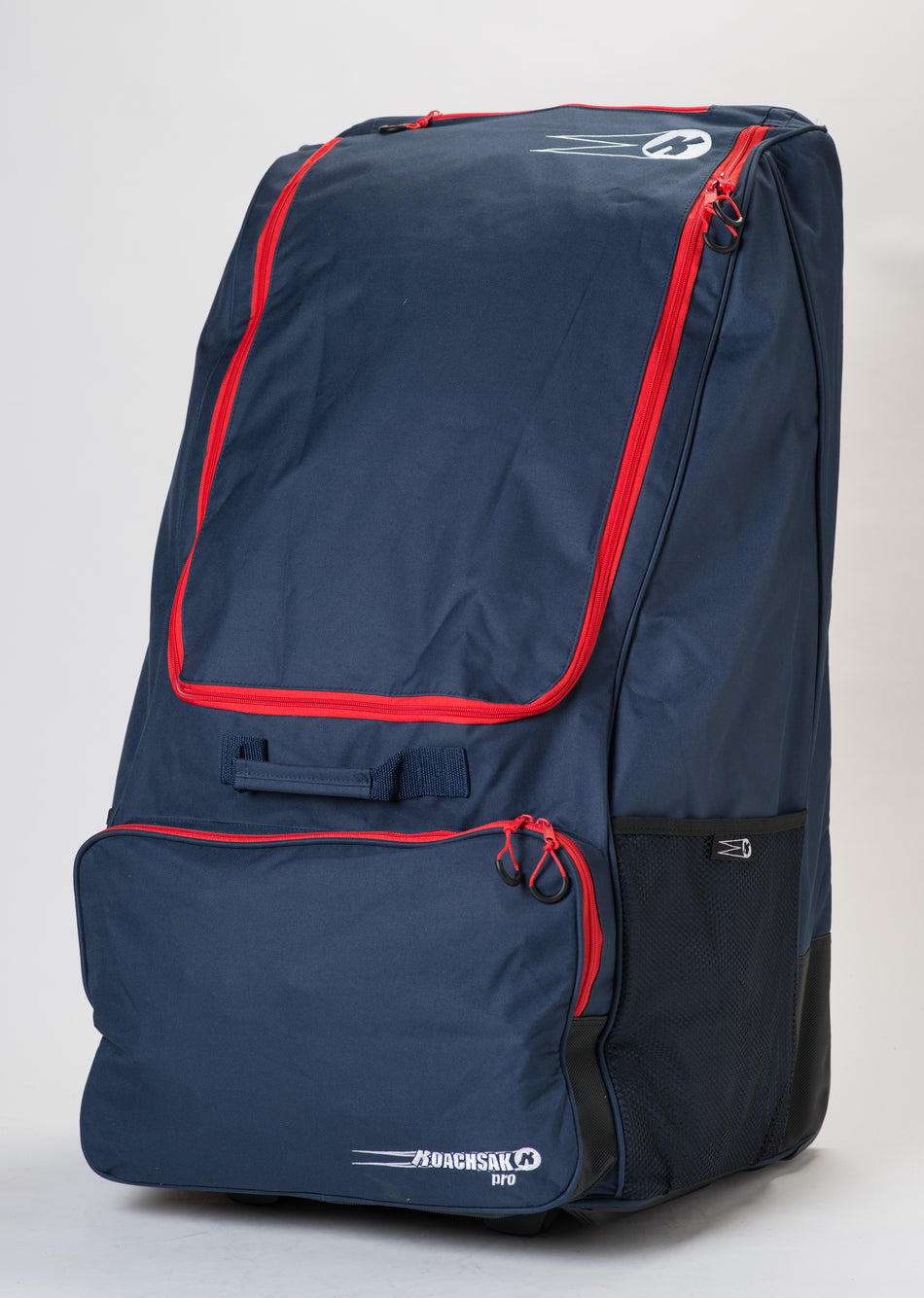 The Katchet KoachSak Pro is a large navy blue sports bag with red zippers, multiple compartments, a mesh side pocket, and "KoachSak Pro" printed in white on the lower front pocket.