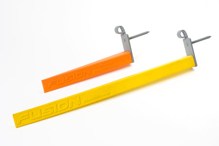 Two rectangular plastic cricket stumps—one orange and one yellow—by Fusion, including the Multi-Stump Shorty, feature flexible design, metal spikes, and loop attachments; shown on a white background.
