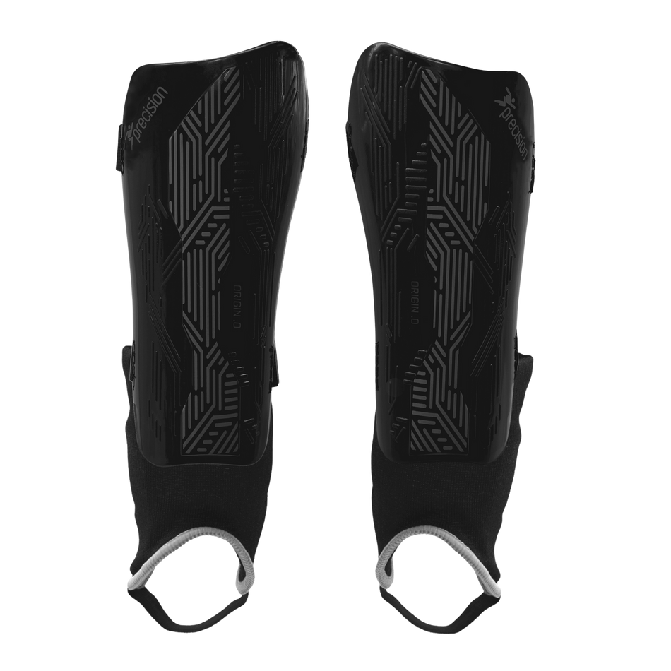 The Precision Training Precision Origin.0 Shin & Ankle Guards in Black/Black feature geometric patterns and black fabric sleeves with white elastic foot loops for football protection, shown on a white background.
