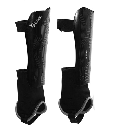 The Precision Training Precision Origin.0 Shin & Ankle Guards are black with attached ankle guards, Velcro straps, a textured finish, and "Precision" printed on one guard for superior football protection.