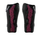 The Precision Training Origin.0 Strap Shin Guards in Black/Pink feature a geometric pink pattern and ORIGIN 0 label, offering high-impact protection with lightweight design, displayed against a white background.