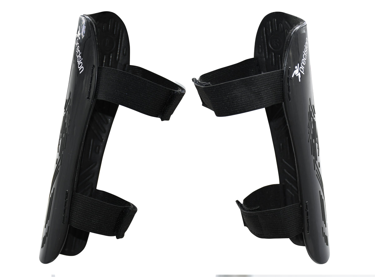 Precision Training Origin.0 Strap Shin Guards in black feature adjustable Velcro straps, are upright and facing each other, and offer high impact protection for sports use.