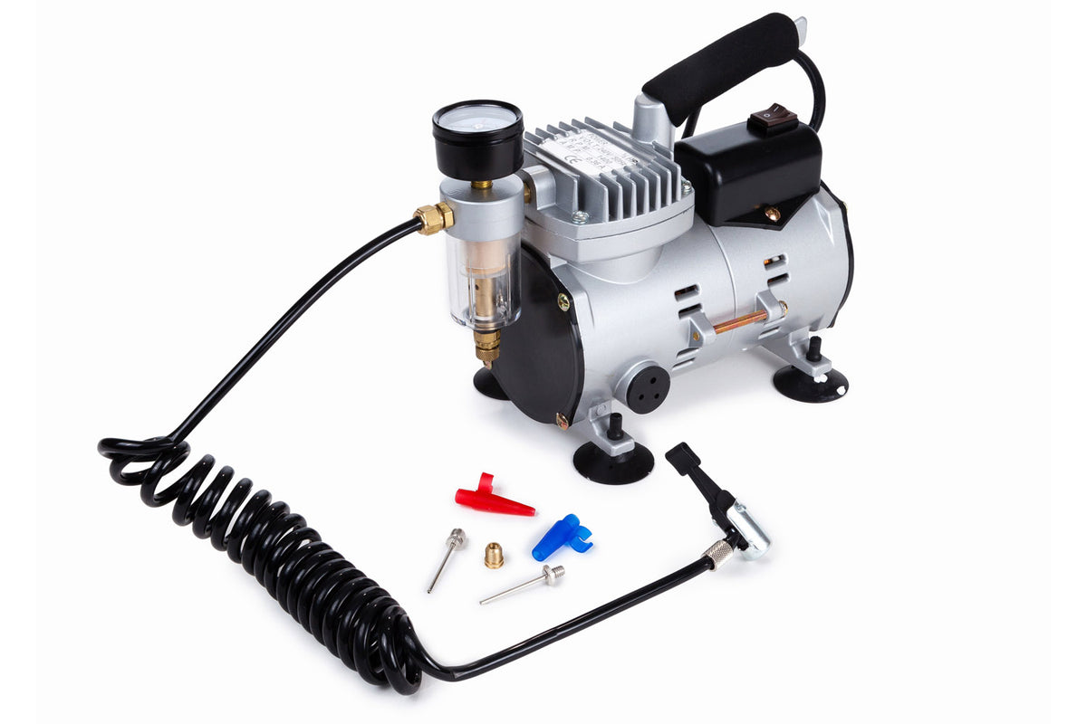 The Samba Sports Samba Electric Ball Pump, a compact mains-powered compressor with pressure gauge, black coiled hose, and assorted nozzles and adapters—ideal for inflating balls—is displayed on a white background.