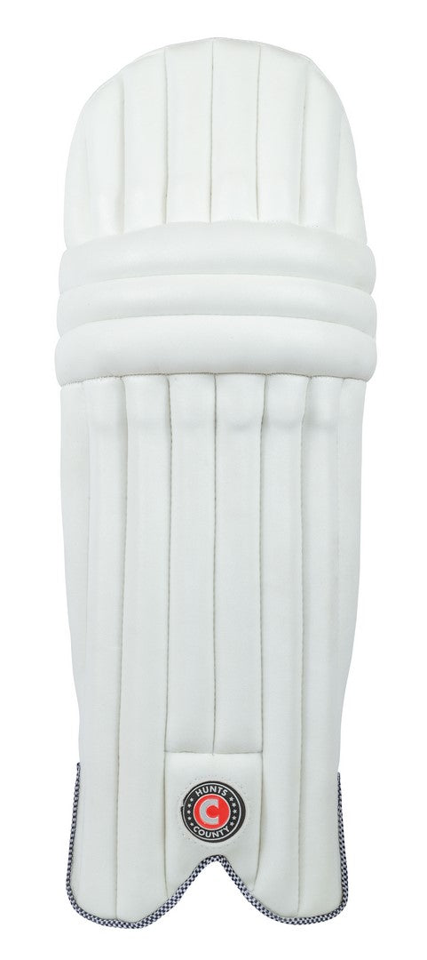 The Hunts County Envy Batting Pads, ambidextrous with vertical grooves and a black round logo near the bottom, are shown in white against a plain background.
