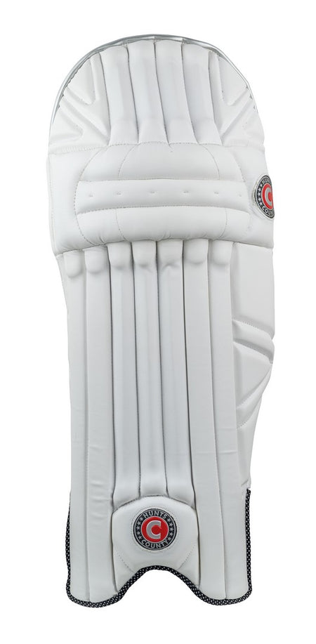 The Hunts County Xero Batting Pads are white, lightweight pads featuring padded vertical sections, a foam padded instep, and two red and black Hunts County logos. They provide leg protection during play.
