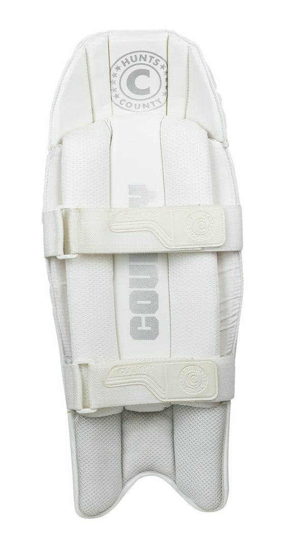 An image of Hunts County Players Grade Wicket Keeping Pads, featuring a white design with two horizontal straps, textured surfaces, reinforced stitching, and the Hunts County brand name at the top and center.