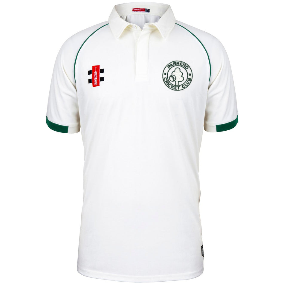 The Parkend CC Matrix V2 Short Sleeve Match Shirt by Martin Berrill Sports is a white shirt with green trim, moisture-wicking fabric, Parkend Cricket Club logo on the left chest, and a red and black rectangular patch on the right.