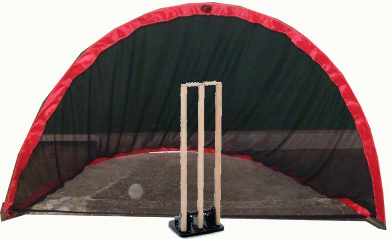 A cricket wicket stands in front of a Hunts County Pop up Backstop/Goal with a red and black frame by Hunts County, set on a concrete surface.