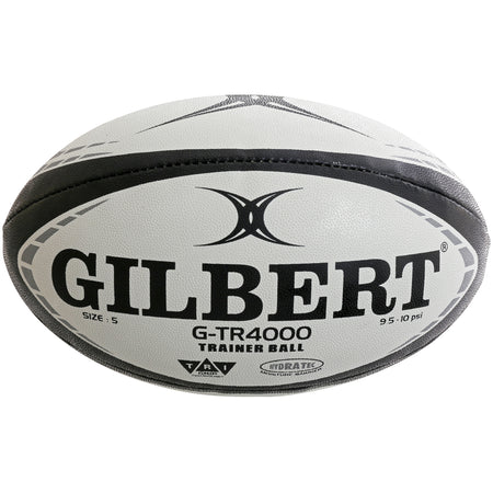 A black Gilbert G-TR4000 Rugby Ball featuring Tri Grip Technology, size 5, the brand name and G-TR4000 Trainer Ball label, with a recommended pressure of 9.5–10 psi.