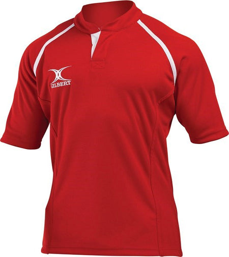 The Gilbert Xact Match Monochrome Rugby Shirt in red features white shoulder accents, a white Gilbert logo on the right chest, a high collar with V-shaped neckline, and durable sportswear fabric for comfort on and off the field.