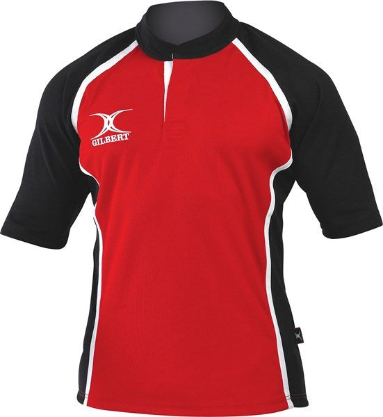 The Gilbert Xact 2 Tone Shirt by Gilbert features a red body, black sleeves and sides, white piping, and a short collar. The white Gilbert name and logo are on the upper left chest. This durable sports shirt is ideal for intense matches.