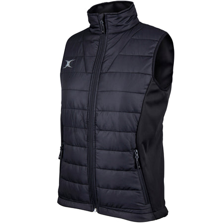 The Gilbert Pro Womens Bodywarmer by Gilbert is a black, water-repellent, sleeveless quilted vest featuring a front zipper, zippered side pockets, high collar, and a small white logo on the upper left chest.