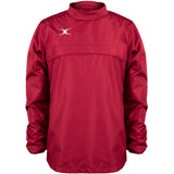 The Gilbert Photon Warm Up Top is a maroon, long-sleeved training top with a high collar, small white Gilbert logo on the upper left chest, smooth fabric, gathered cuffs, and a loose fit.