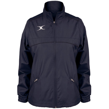 The Gilbert Photon Women's Full Zip Jacket by Gilbert is a navy blue rugby jacket featuring a high collar, two front zippered pockets, and a white abstract logo on the left chest. Shown on a plain white background.