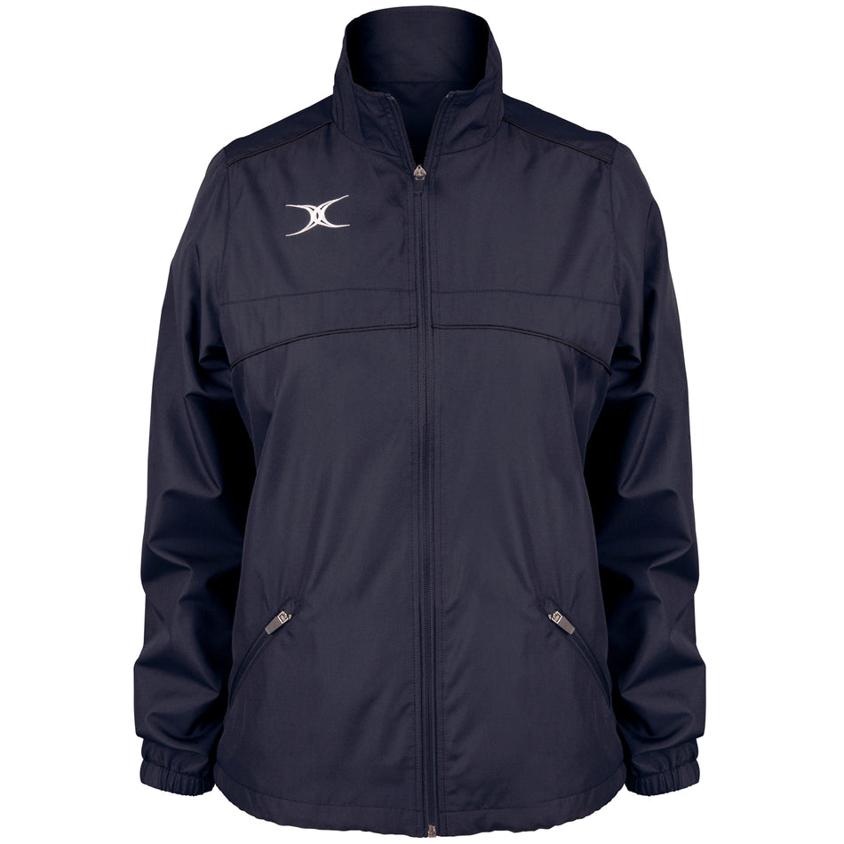 The Gilbert Photon Women's Full Zip Jacket by Gilbert is a navy blue rugby jacket featuring a high collar, two front zippered pockets, and a white abstract logo on the left chest. Shown on a plain white background.