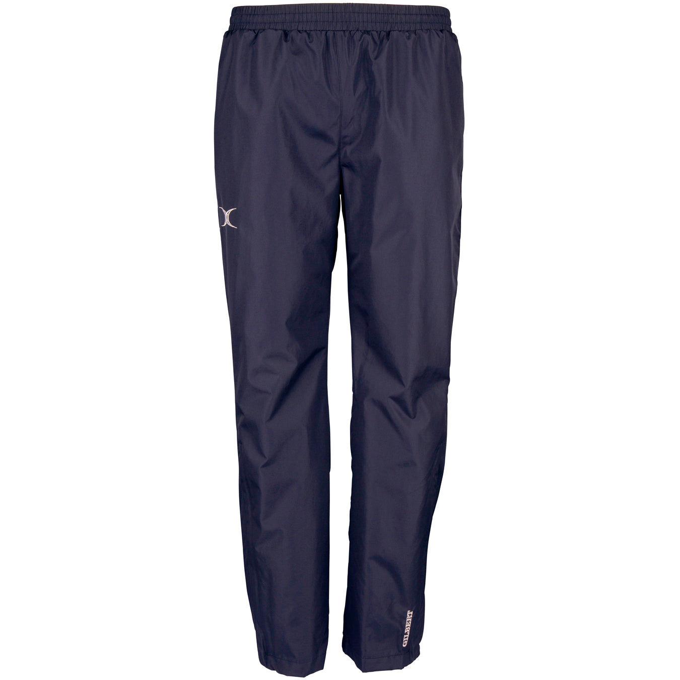 The Gilbert Photon Training Trouser by Gilbert is a navy blue, lightweight over trouser with an elastic waistband, straight legs, breathable water-repellent fabric, and subtle reflective logos on the thigh and lower leg.