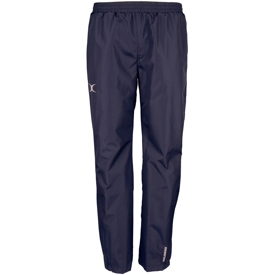 The Gilbert Photon Training Trouser by Gilbert is a navy blue, lightweight over trouser with an elastic waistband, straight legs, breathable water-repellent fabric, and subtle reflective logos on the thigh and lower leg.