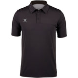 The Gilbert Pro Tech Polo by Gilbert is a black short-sleeve polo with a collar, three buttons, moisture-wicking fabric, and a small white abstract logo on the left chest—ideal for stylish off-field wear.