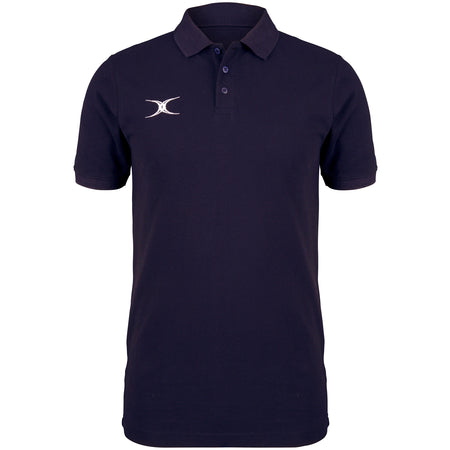 The Gilbert Quest Polo by Gilbert is a plain navy blue organic cotton polo with short sleeves, a three-button placket, and a small white abstract logo on the left chest.
