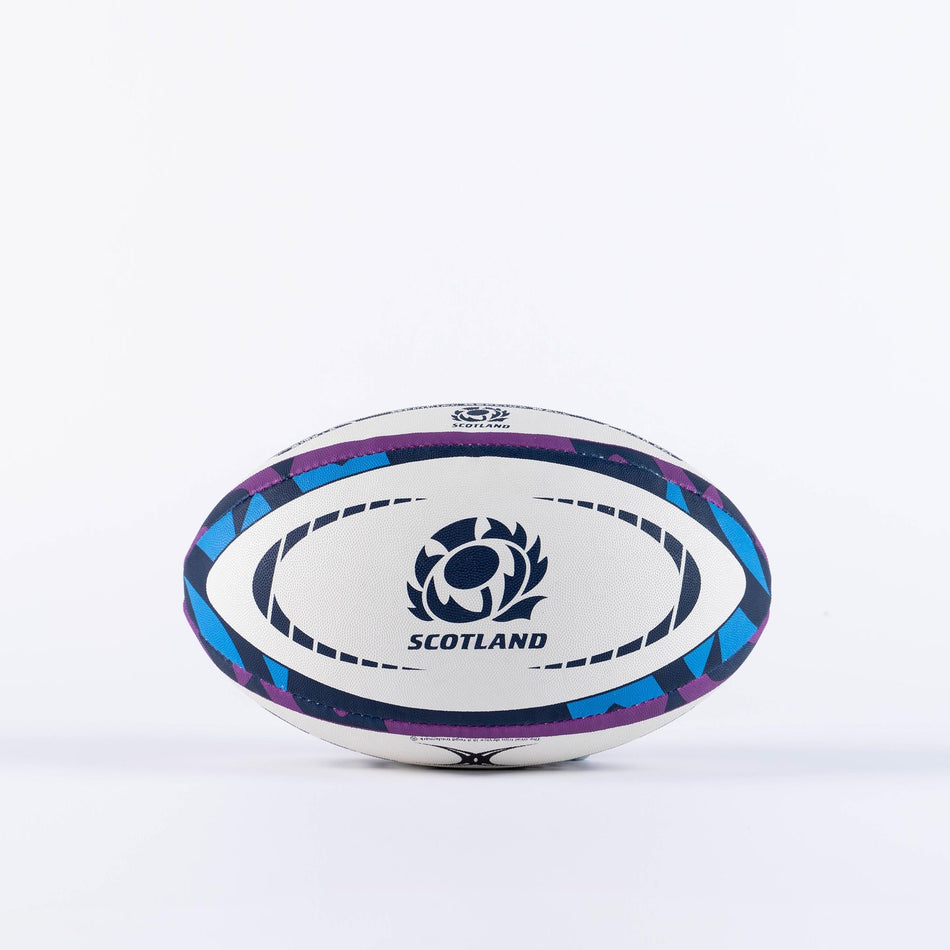 The Gilbert Scotland Replica Rugby Ball by Gilbert features blue and purple patterns, the Scotland rugby logo, and bold "SCOTLAND" lettering—ideal for passionate fans. Displayed on a plain white background.