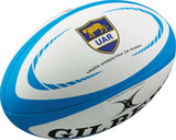 The Gilbert Argentina Replica Rugby Ball is a white and blue ball featuring the Unión Argentina de Rugby emblem and Gilbert logo—perfect for Pumas fans and collectors.
