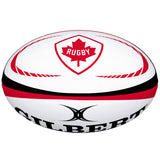 The Gilbert Canada Replica Rugby Ball by Gilbert features red and black accents, a red maple leaf and "Rugby" in the center—making it an ideal piece for any World Cup memorabilia collection.