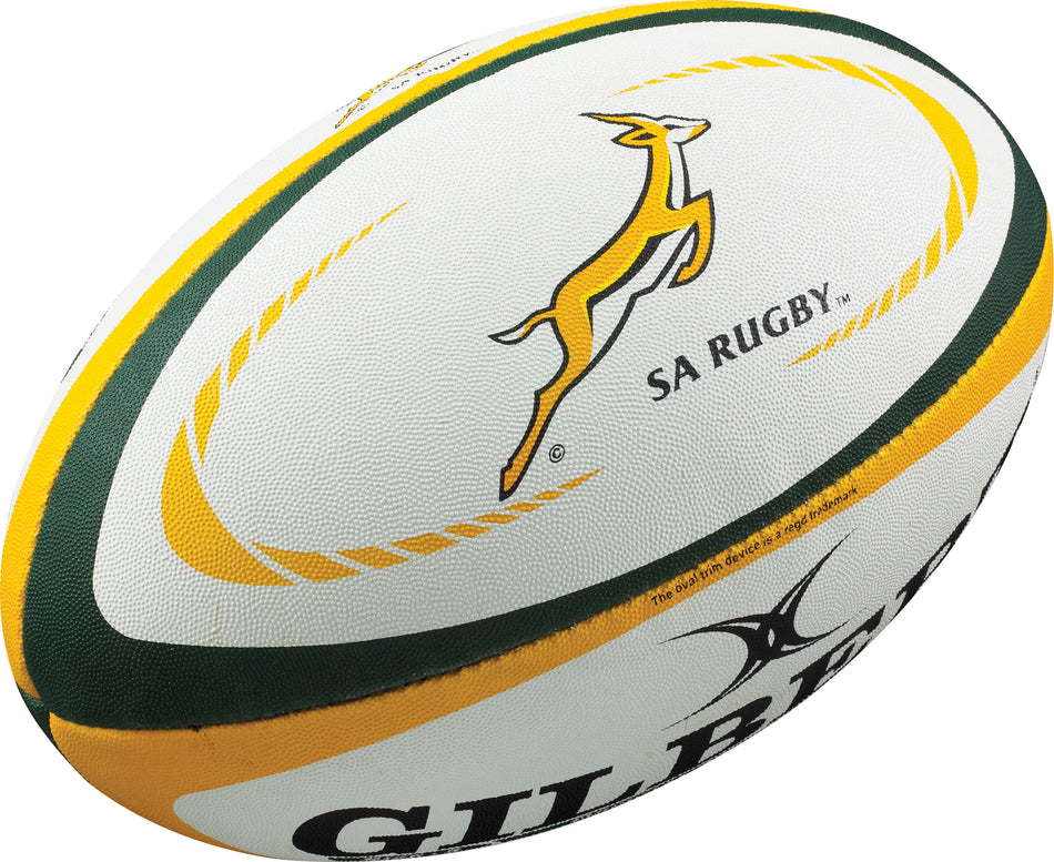 The Gilbert South Africa Replica Rugby Ball features white and yellow colors with green accents, a springbok logo, SA RUGBY text, and the Gilbert brand—an essential piece of Rugby World Cup memorabilia.