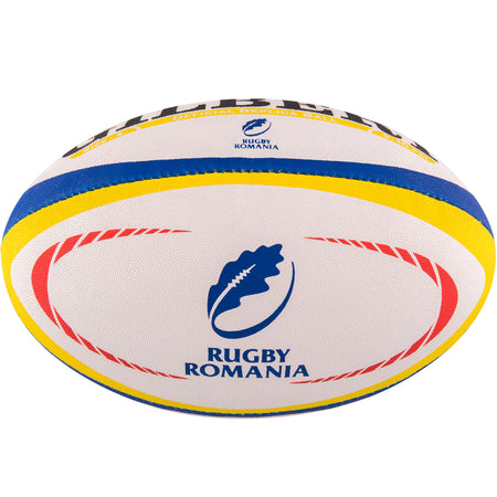 The Gilbert Romania Replica Rugby Ball by Gilbert features red, yellow, and blue stripes, plus the Rugby Romania logo with a blue oak leaf and "RUGBY ROMANIA" text—a must-have for passionate Romania supporters.