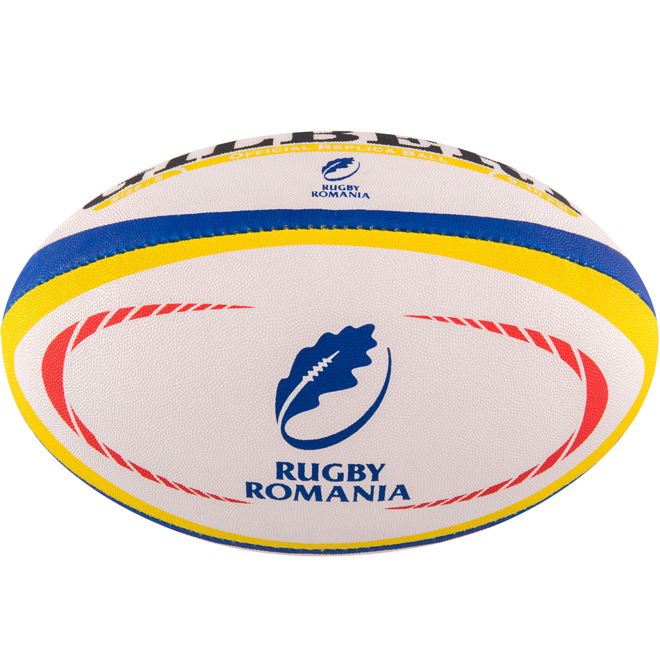 The Gilbert Romania Replica Rugby Ball by Gilbert features red, yellow, and blue stripes, plus the Rugby Romania logo with a blue oak leaf and "RUGBY ROMANIA" text—a must-have for passionate Romania supporters.