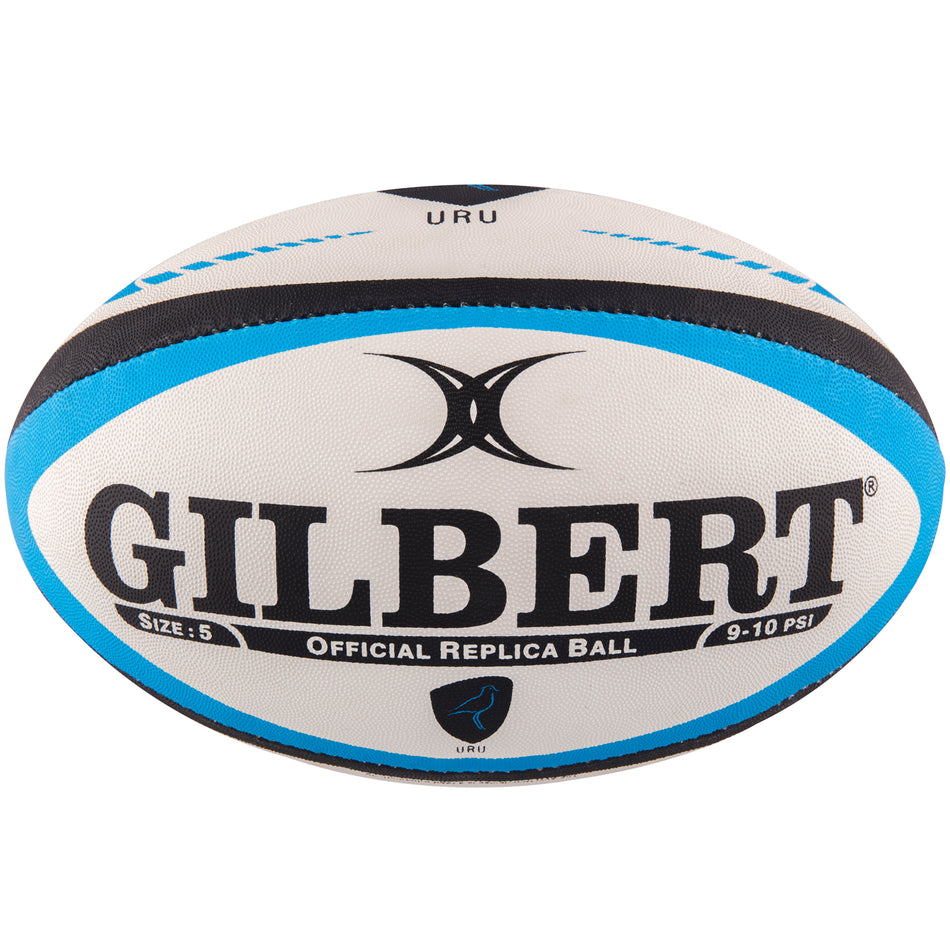 The Gilbert Uruguay Replica Rugby Ball is a white size 5 ball with black and blue accents, displaying the Gilbert logo, Rugby World Cup 2023 text, and has an official replica design with a pressure range of 9-10 PSI.