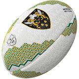 The Gilbert Northampton Saints Supporter Rugby Ball features green and yellow geometric patterns, a black and gold crest with castle and lions, plus the Gallagher Premiership Rugby logo—a must for any fan.