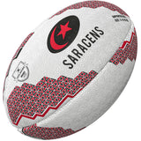 The Gilbert Saracens Supporter Rugby Ball by Gilbert features red and black geometric patterns, the word SARACENS, a red star in a crescent, and logo—ideal rugby memorabilia for any Premiership Rugby fan.